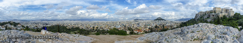 Panoramic view of Athens city, Greece from the National Observatory of Athens (left) to Acropolis (right). Vantage point of Areopagus hill in Plaka. Sunny day with cloudy blue sky