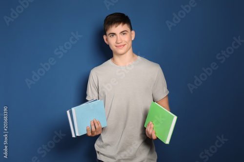 Teenage boy with books on c...