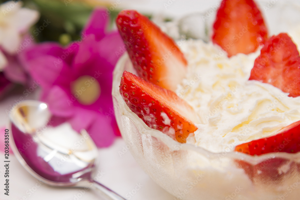 glass bowl of strawberries with cream with spring background glass bowl of strawberries with cream with spring background