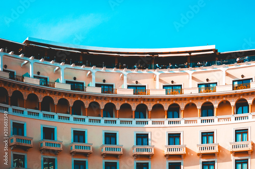 curved building with long orange balcony