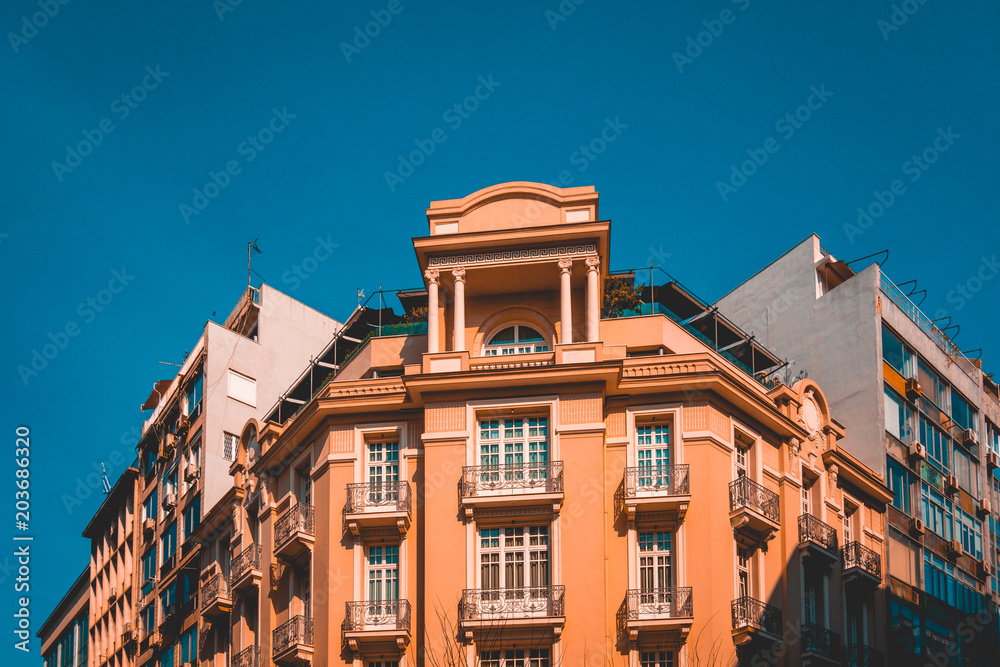 orange corner building with darken blue sky