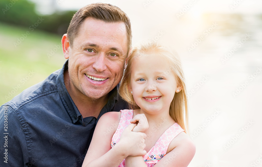 Fototapeta premium Young Caucasian Father and Daughter Having Fun At The Park