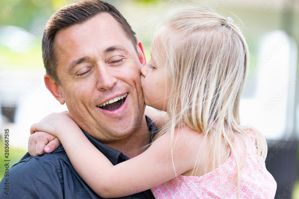 Young Caucasian Father and Daughter Having Fun At The Park Young Caucasian Father and Daughter Having Fun At The Park