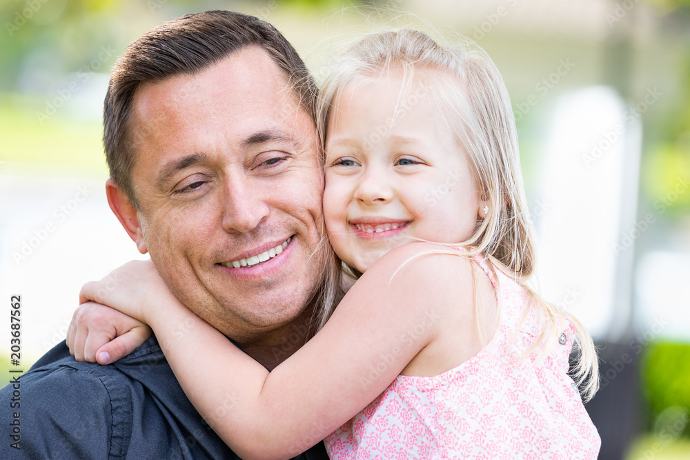 Young Caucasian Father and Daughter Having Fun At The Park Young Caucasian Father and Daughter Having Fun At The Park