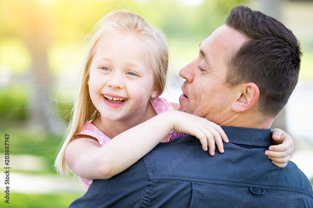 Fototapeta premium Young Caucasian Father and Daughter Having Fun At The Park