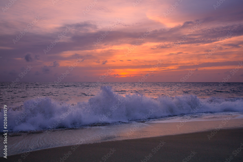 Fototapeta premium View of the sunset at Mai Khao Beach in Phuket, Thailand