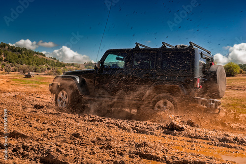 All-terrain vehicle passing through an area of mud