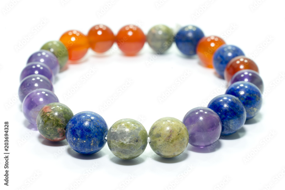 Unakite, lapis lazuli, Carnelian and Amethyst bracelet isolated on white background. Unakite, lapis lazuli, Carnelian and Amethyst bracelet isolated on white background.
