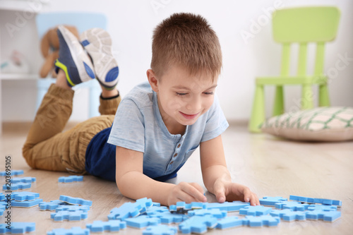Cute little boy playing wit...
