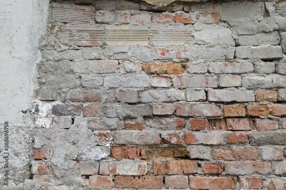 Weathered red brick wall background with spots Weathered red brick wall background with spots