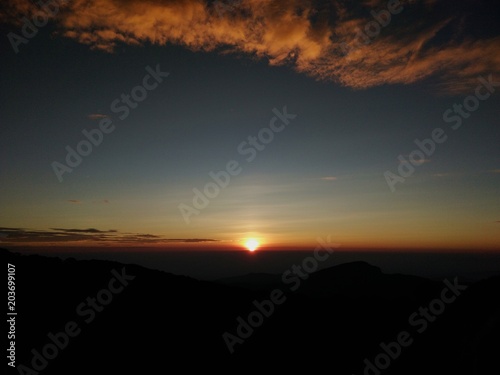 Landscape of Sunrise on top of mountain with view into misty valley.Foggy mountain in Chiangmai province Thailand