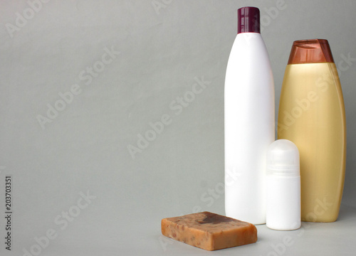 Body care products on grey background, copy space