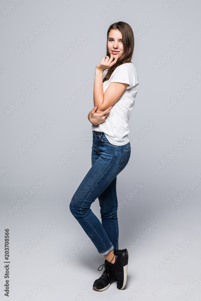 Full body portrait of happy smiling beautiful young woman, isolated over gray background Full body portrait of happy smiling beautiful young woman, isolated over gray background