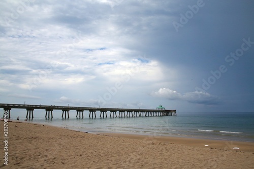 South Side of Deerfield Beach, Florida Pier under Dark Ominious Foreboding Storm Clouds in June photo