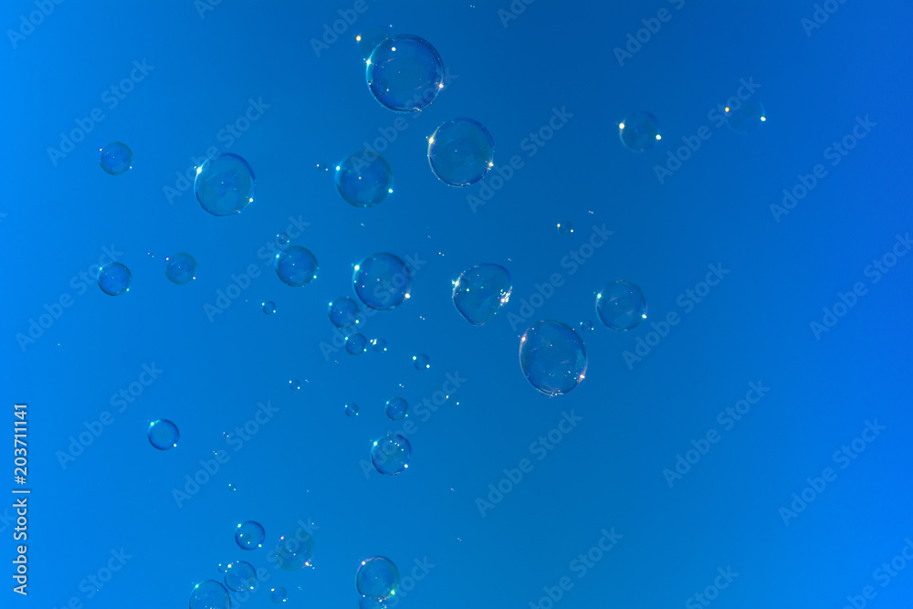 Soap bubbles, Blowing soap bubble on Blue sky background