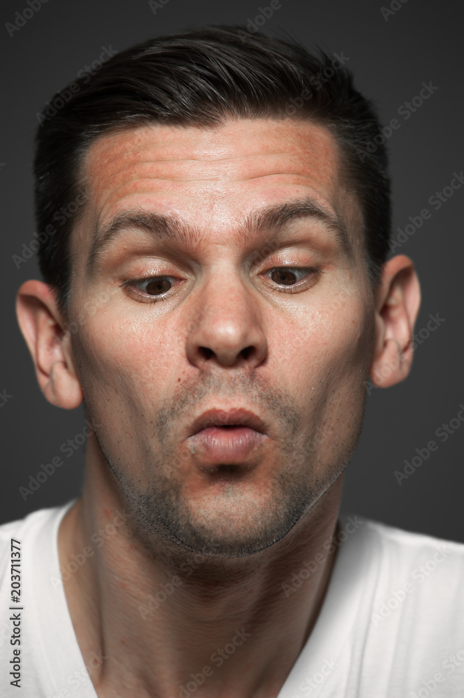 Close-up portrait of surprised caucasian man on gray background Close-up portrait of surprised caucasian man on gray background