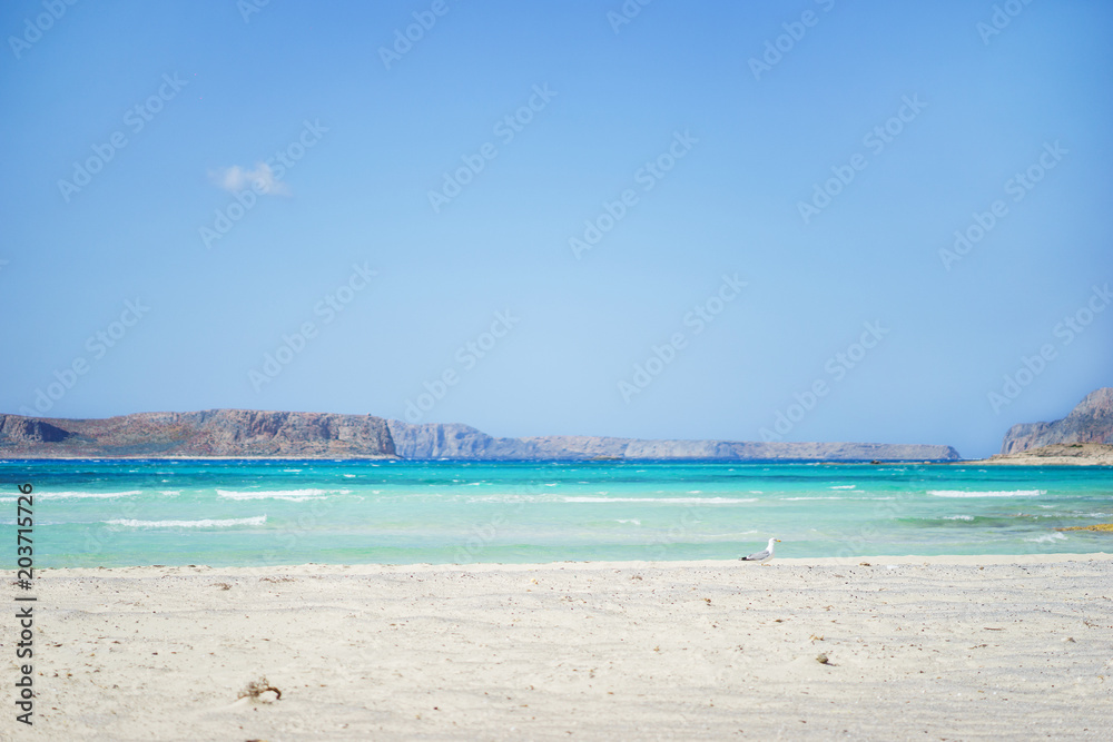 Magical landscape - rocks and clean transparent sea waves on the beach with white sand.