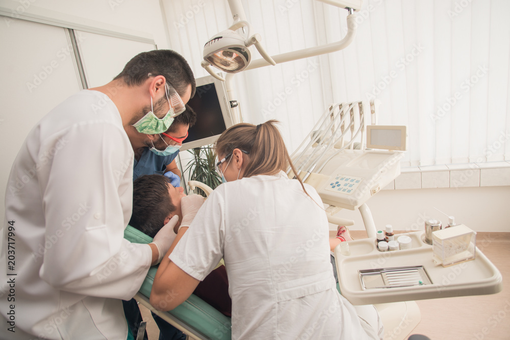 Boy with perfect teeth at the dentist doing check up with the clinic at the background - oral hygiene health care concept Boy with perfect teeth at the dentist doing check up with the clinic at the background - oral hygiene health care concept