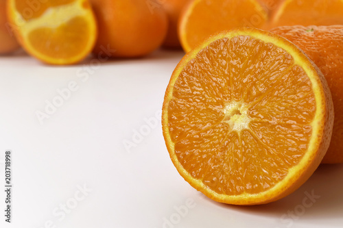 natural oranges in the foreground  macro shot with a reflection  free space for text on a white background