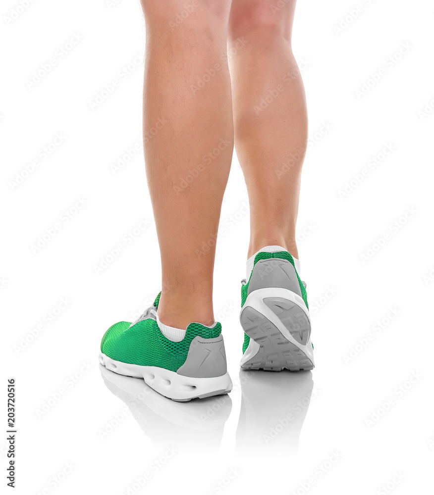 Male legs in sneakers over white. Male legs in sneakers over white.