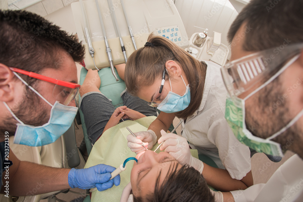 Boy with perfect teeth at the dentist doing check up with the clinic at the background - oral hygiene health care concept Boy with perfect teeth at the dentist doing check up with the clinic at the background - oral hygiene health care concept