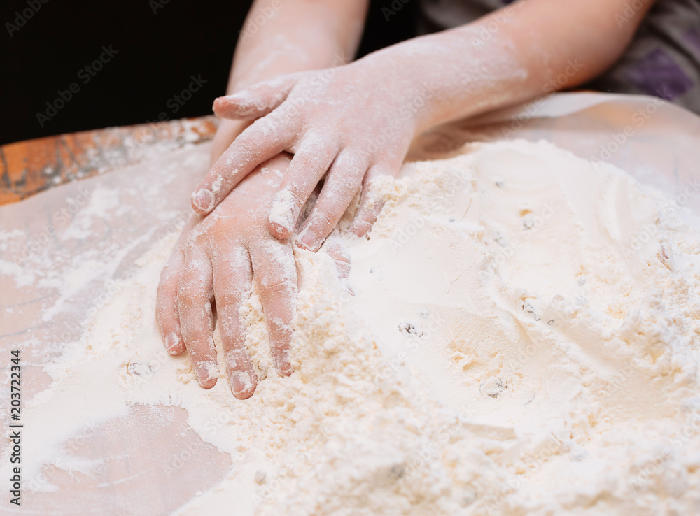 kid's hands in a flour with raisins kid's hands in a flour with raisins