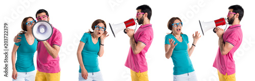 Couple in colorful clothes shouting by megaphone