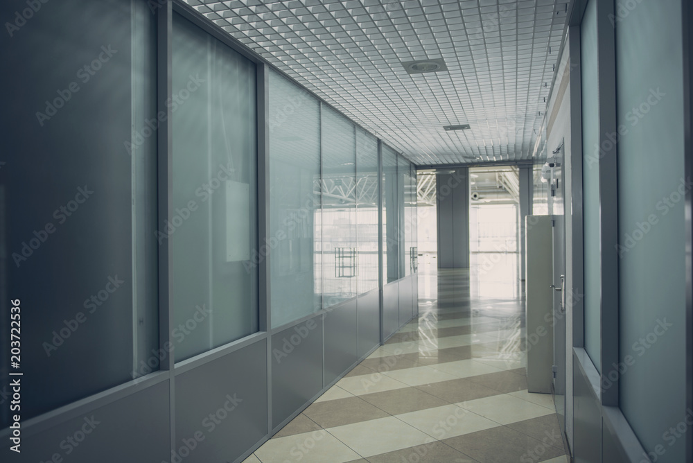 Dark corridor with entrance in another bright unknown room Dark corridor with entrance in another bright unknown room