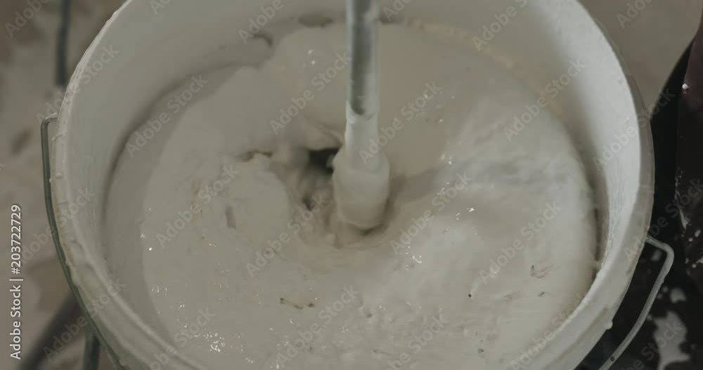 slow motion stirring putty in the bucket slow motion stirring putty in the bucket