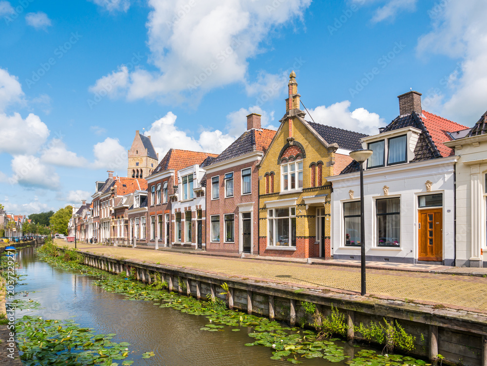 Canal and tower of church in old town of Bolsward, Friesland, Netherlands