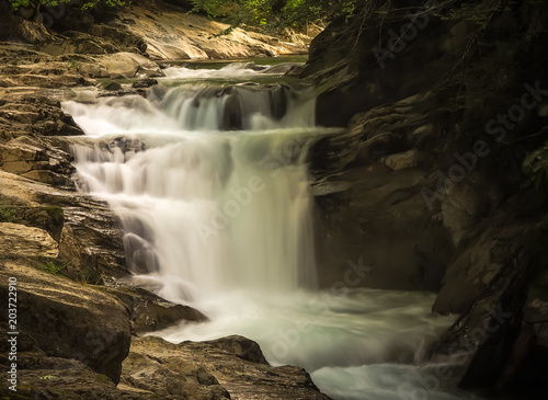 waterfall with long exposure and rocky mountain