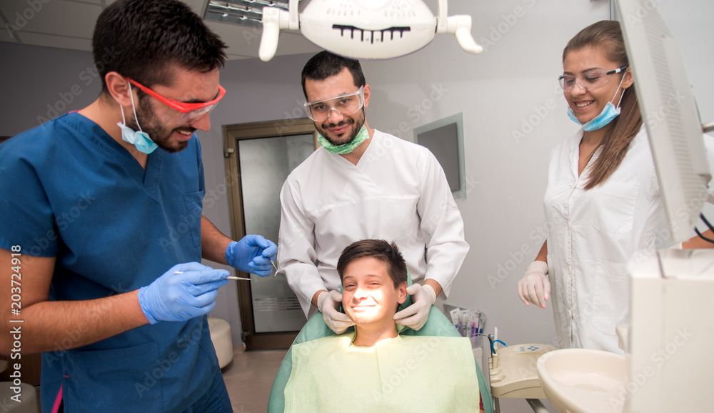 Boy with perfect teeth at the dentist doing check up with the clinic at the background - oral hygiene health care concept Boy with perfect teeth at the dentist doing check up with the clinic at the background - oral hygiene health care concept