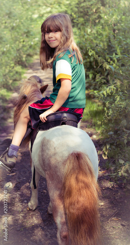 Beautiful Girl Child Riding into Woods on Miniature Horse