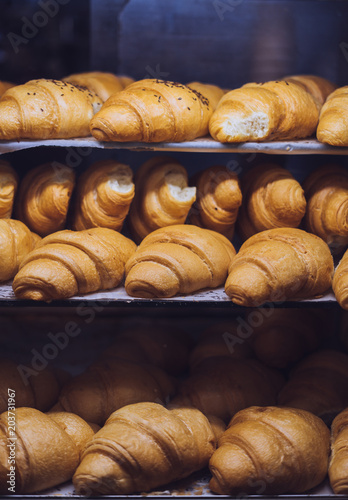 A lot of fresh homemade croissants Sold in a small bakery.