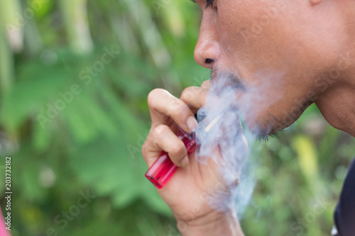 a man is smoking and it is a concept about carcinogens