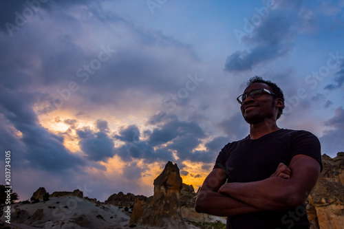 Young black man posing in front of Frig ruins