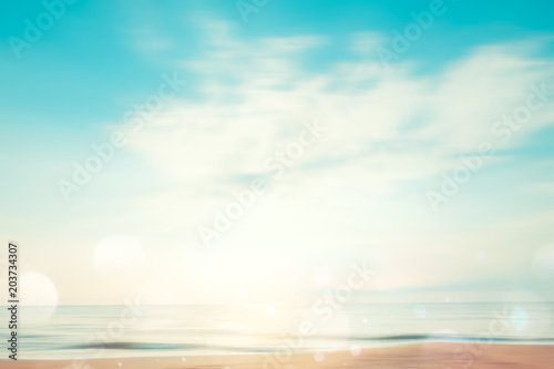 A seascape abstract beach background. panning motion blur and bokeh light of lens flare  pastel colors in a vintage and retro style.