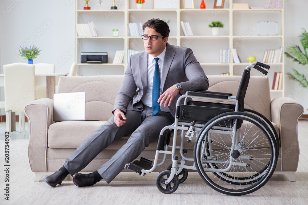 Dsabled businessman on wheelchair working home Dsabled businessman on wheelchair working home