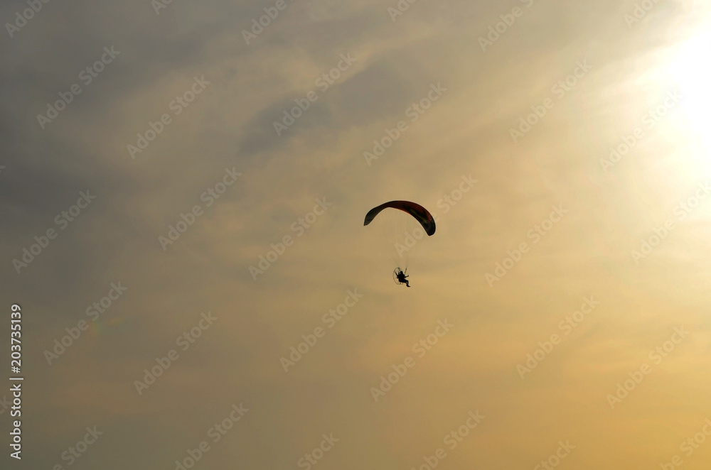 motoparaplane against the sky and the sun.. Above the Mediterranean Sea, Israel.. Extreme sports, enjoy life, value the moment,.Fly towards the sun motoparaplane against the sky and the sun.. Above the Mediterranean Sea, Israel.. Extreme sports, enjoy life, value the moment,.Fly towards the sun