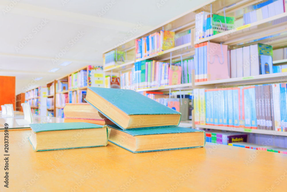 old book red - green. and heap treatise in school library on wooden table. blurry bookshelves background. education learning concept with copy space add text old book red - green. and heap treatise in school library on wooden table. blurry bookshelves background. education learning concept with copy space add text