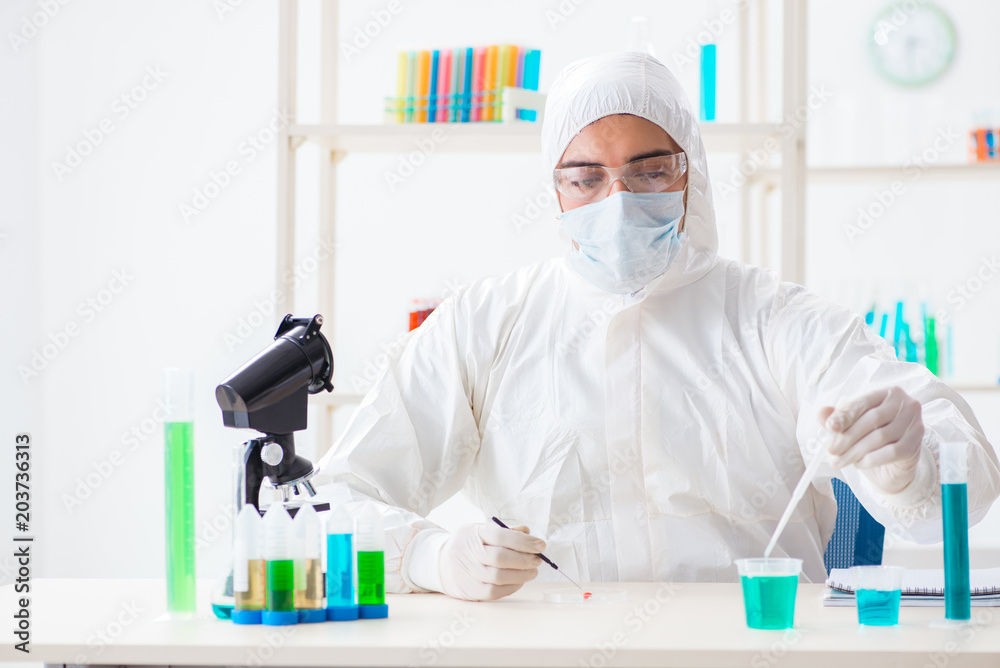 Young chemist student working in lab on chemicals Young chemist student working in lab on chemicals