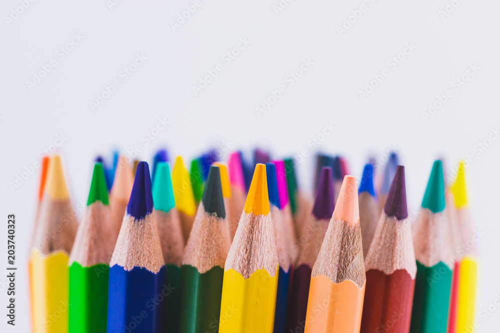 Close up seamless colored pencils row isolated on white background. Colorful pencils with copy space for your text. Close up seamless colored pencils row isolated on white background. Colorful pencils with copy space for your text.