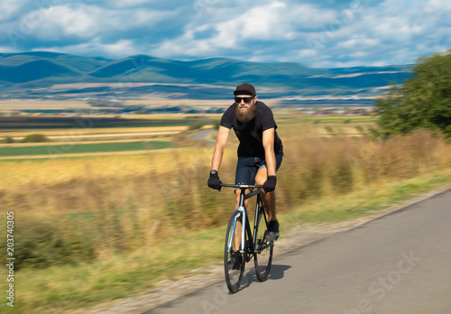 Fototapeta Naklejka Na Ścianę i Meble -  Natural view with cyclist going somewhere with stylish bike