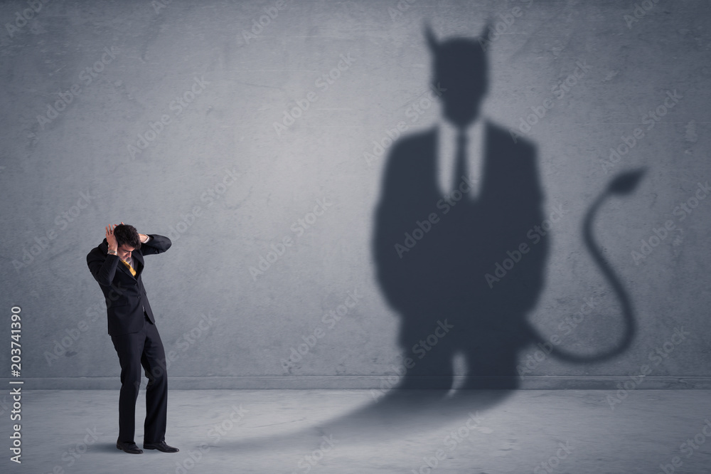 Fototapeta premium Business man looking at his own devil demon shadow concept background