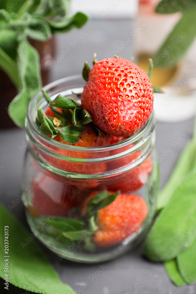 Fresh cocktail with ripe strawberry and sage leaves. Selective focus. Fresh cocktail with ripe strawberry and sage leaves. Selective focus.