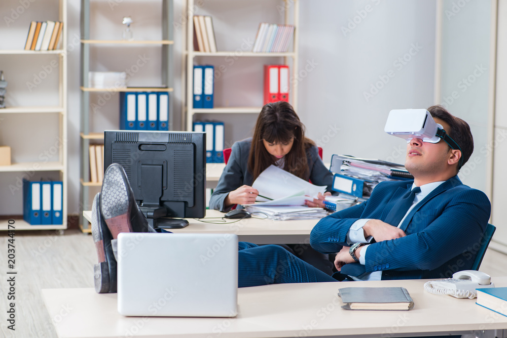 Employee with virtual reality glasses in office Employee with virtual reality glasses in office