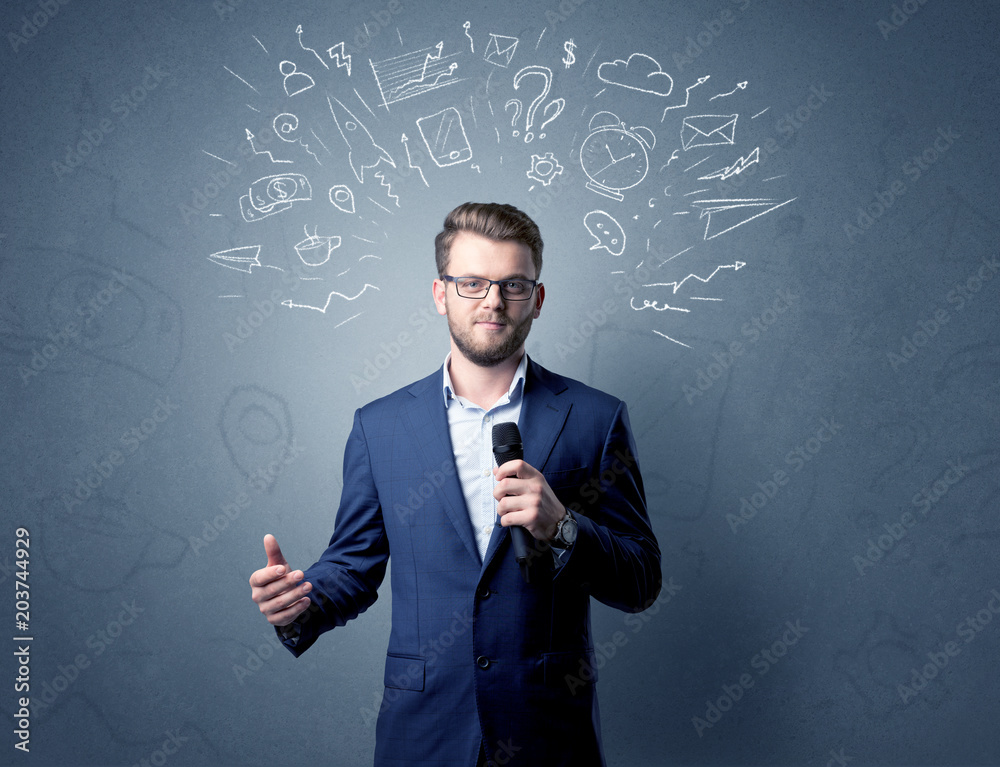 Businessman speaking into microphone with mixed doodles over his head Businessman speaking into microphone with mixed doodles over his head