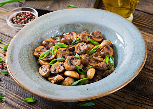 Baked mushrooms with soy sauce and herbs. Vegan food.