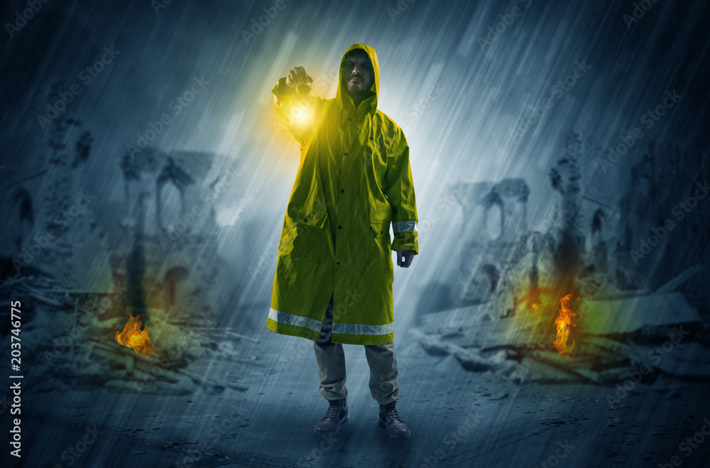 Obraz premium Destroyed place after a catastrophe with man in raincoat and lantern concept 