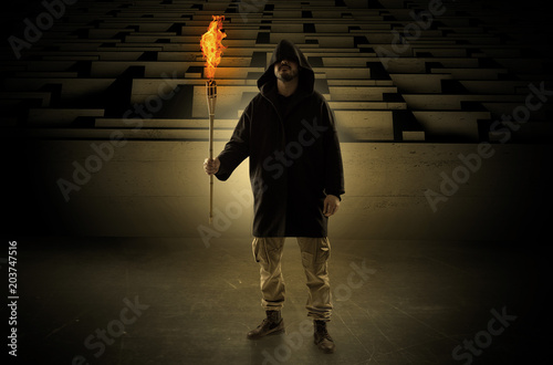 Canvas Print Ugly, aberrant man coming out from the labyrinth with burning flambeau on his ha